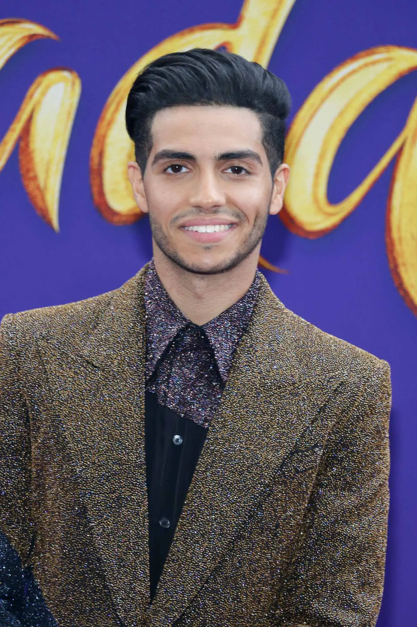 What is Mena Massoud height in feet and cm? We break down his height details clearly.